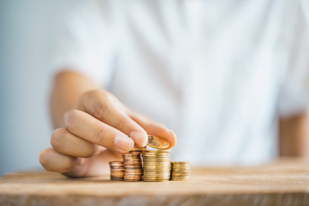 person stacking coins