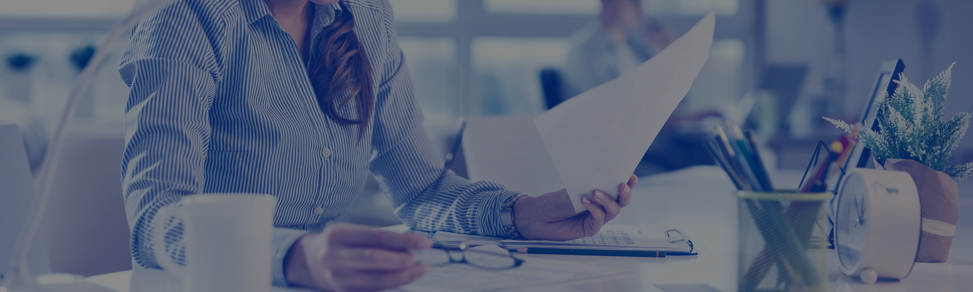 Young businesswoman working on paperwork in the office
