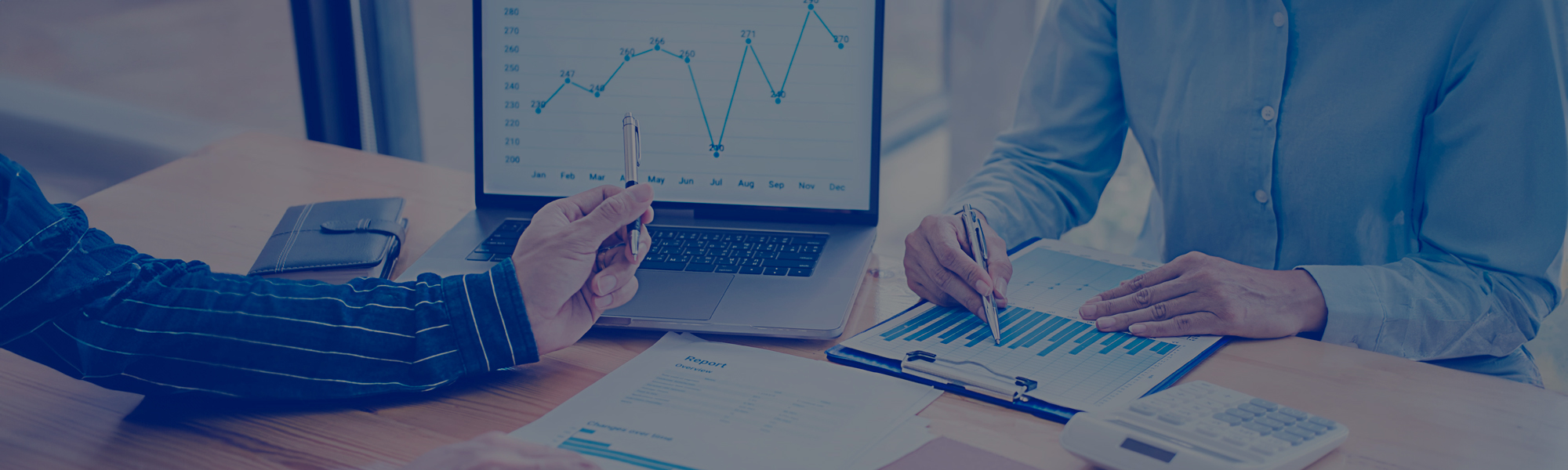 Business people discussing the charts and graphs showing the results of their successful teamwork